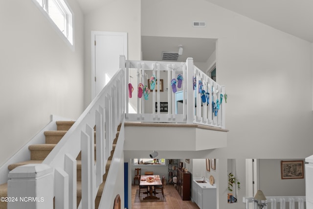 stairway with high vaulted ceiling and sink