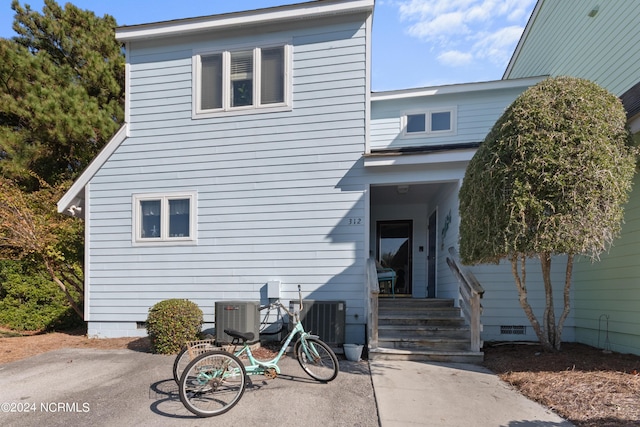 back of house with central air condition unit and a patio