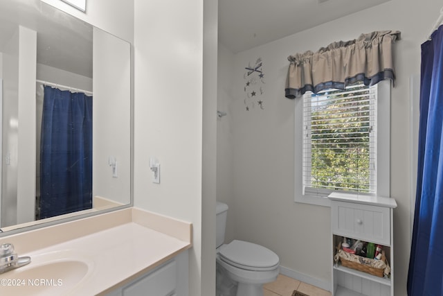 bathroom featuring tile patterned flooring, vanity, and toilet