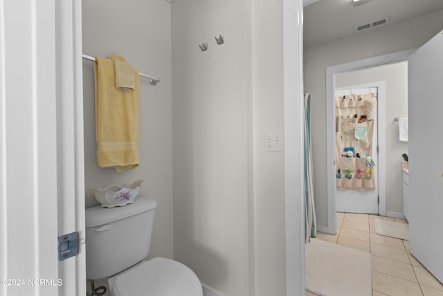 bathroom featuring tile patterned flooring and toilet