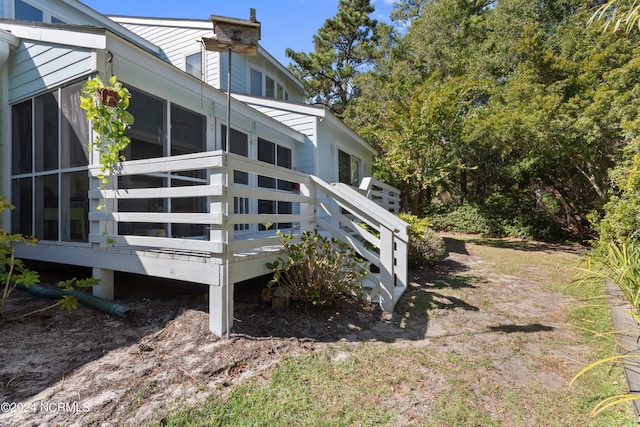 view of side of home featuring a sunroom