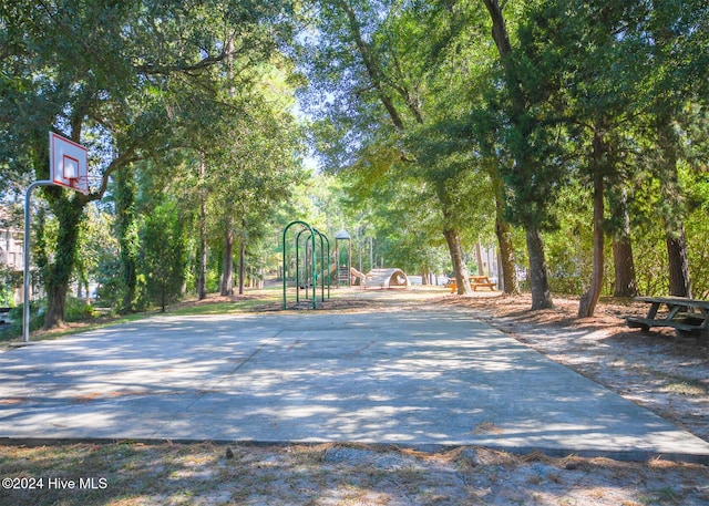 view of basketball court with a playground