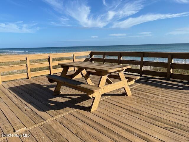 deck featuring a water view and a view of the beach