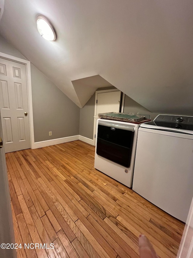 washroom featuring washer and dryer and light hardwood / wood-style floors