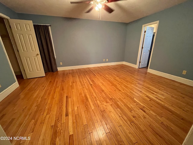 unfurnished bedroom featuring ceiling fan and light hardwood / wood-style flooring