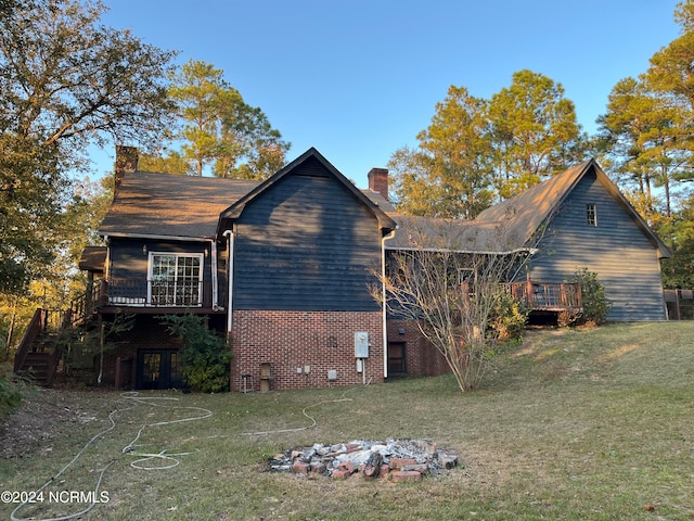 view of property exterior featuring a wooden deck and a yard