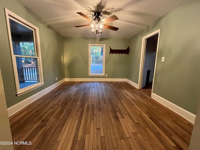 spare room with ceiling fan and dark hardwood / wood-style flooring