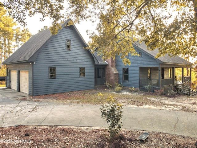 exterior space with a porch and a garage