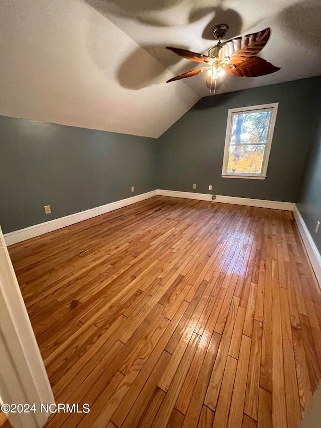 additional living space featuring light hardwood / wood-style floors, lofted ceiling, and ceiling fan