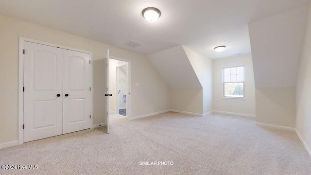 bonus room featuring light colored carpet and lofted ceiling