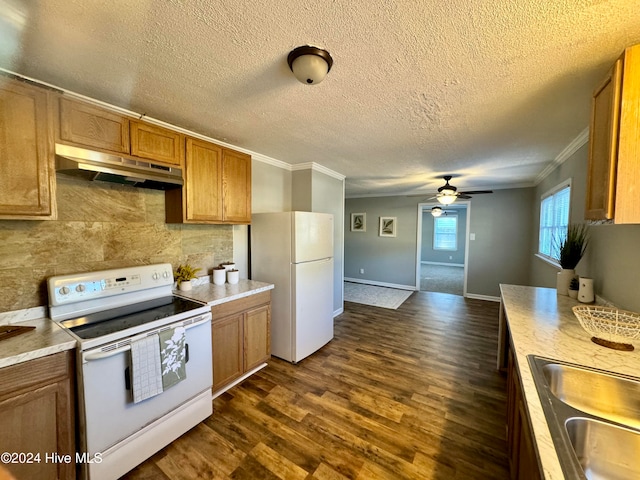 kitchen with decorative backsplash, white appliances, crown molding, and dark wood-type flooring