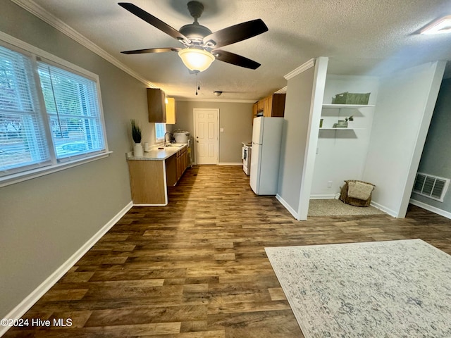 interior space with a textured ceiling, dark hardwood / wood-style flooring, ceiling fan, and ornamental molding