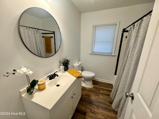 bathroom with vanity, wood-type flooring, and tiled shower / bath