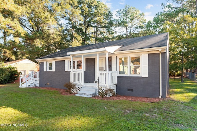 single story home with a front yard and covered porch