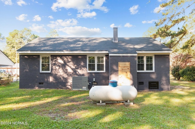 view of side of property with a lawn and central AC unit