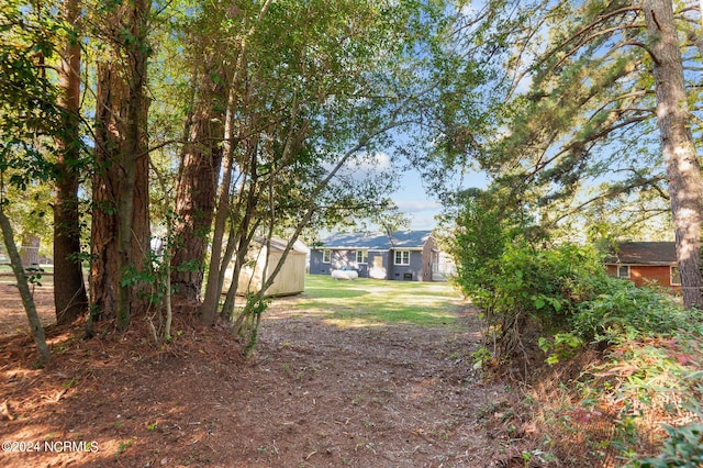 rear view of house with a yard and central AC unit