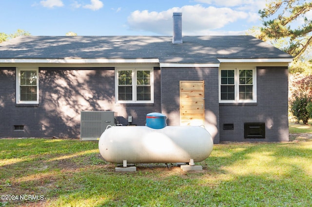 rear view of house with a yard and central air condition unit