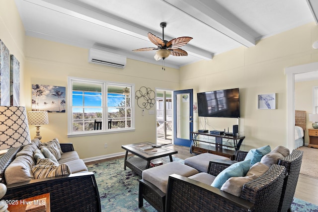 living area with a ceiling fan, wood finished floors, a wall mounted air conditioner, beamed ceiling, and baseboards