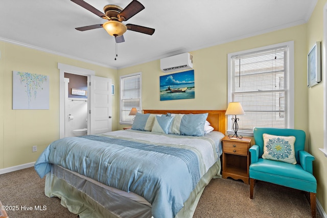 carpeted bedroom featuring a ceiling fan, a wall mounted air conditioner, crown molding, and ensuite bathroom