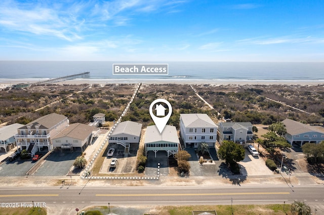 bird's eye view with a water view, a residential view, and a view of the beach