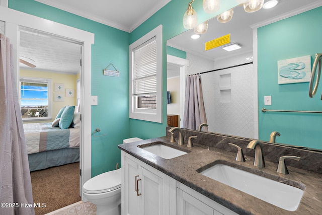 bathroom featuring ornamental molding, a sink, ensuite bath, and toilet