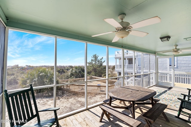 sunroom featuring a ceiling fan