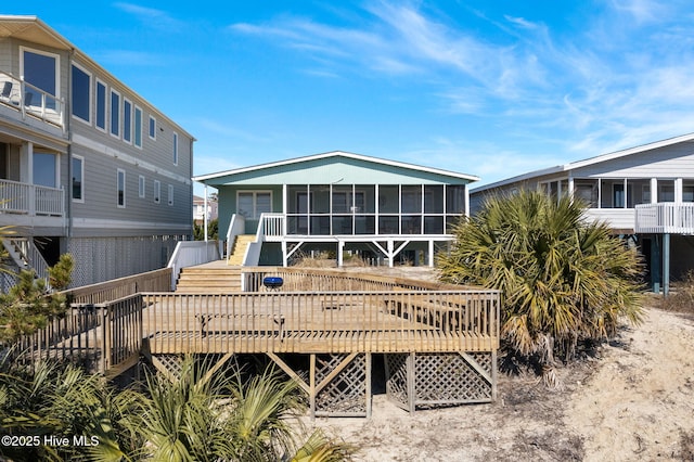 back of house with a deck and a sunroom