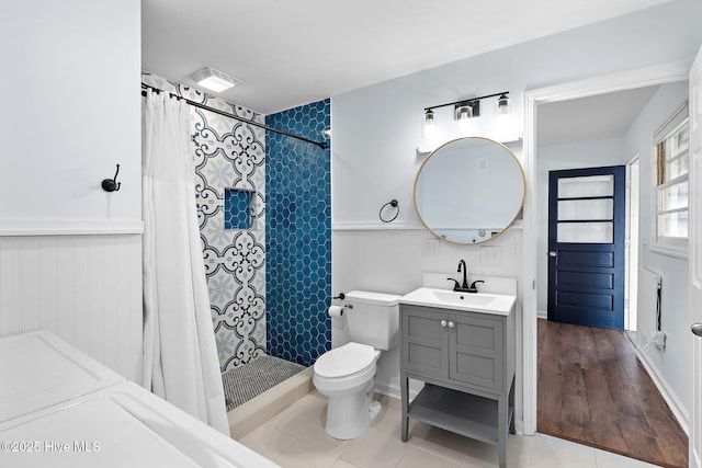 bathroom with visible vents, tiled shower, toilet, tile patterned floors, and vanity