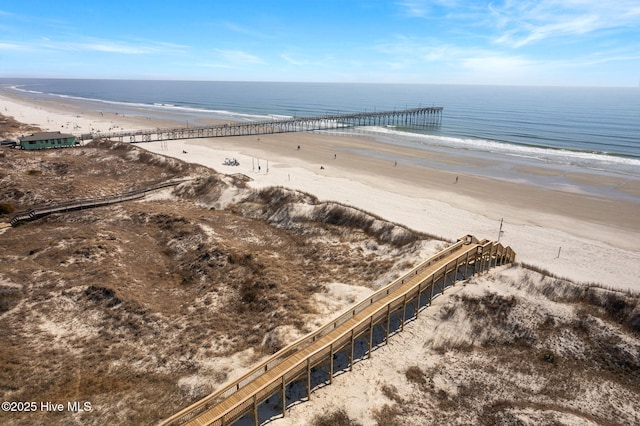 bird's eye view featuring a water view and a beach view