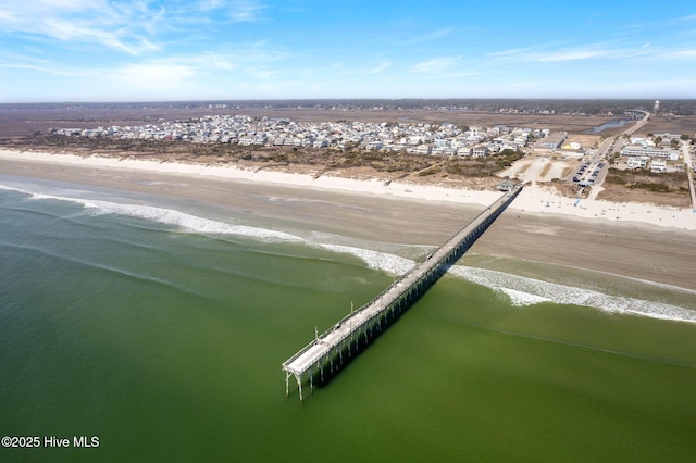 aerial view with a water view and a beach view