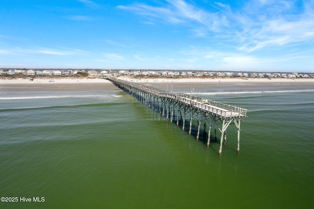 bird's eye view with a water view and a beach view