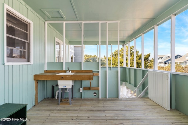 unfurnished sunroom with a sink