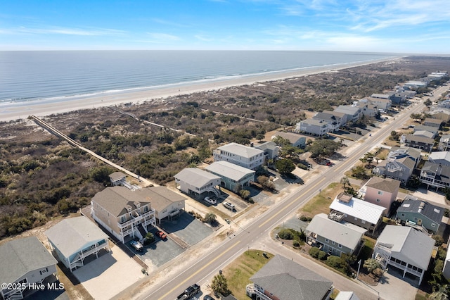 bird's eye view featuring a water view and a beach view