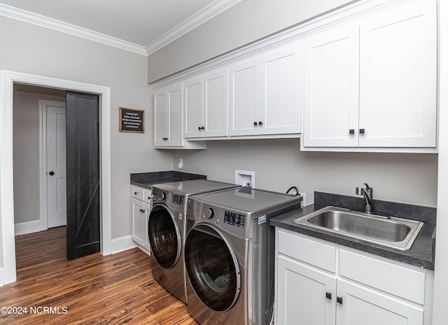 washroom with sink, dark hardwood / wood-style flooring, cabinets, independent washer and dryer, and crown molding