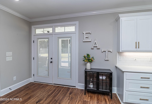 doorway with ornamental molding, dark hardwood / wood-style floors, and french doors