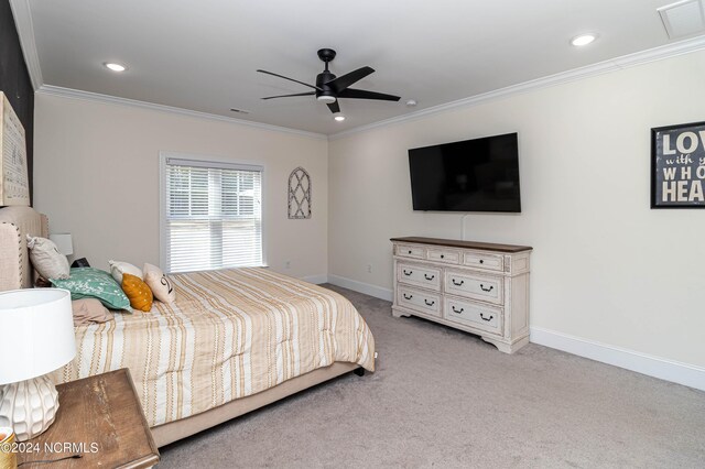 carpeted bedroom with crown molding and ceiling fan