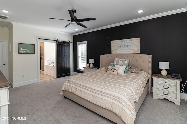 carpeted bedroom featuring ornamental molding, a barn door, ensuite bathroom, and ceiling fan