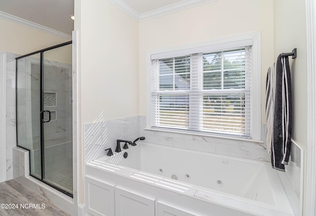 bathroom featuring ornamental molding and shower with separate bathtub