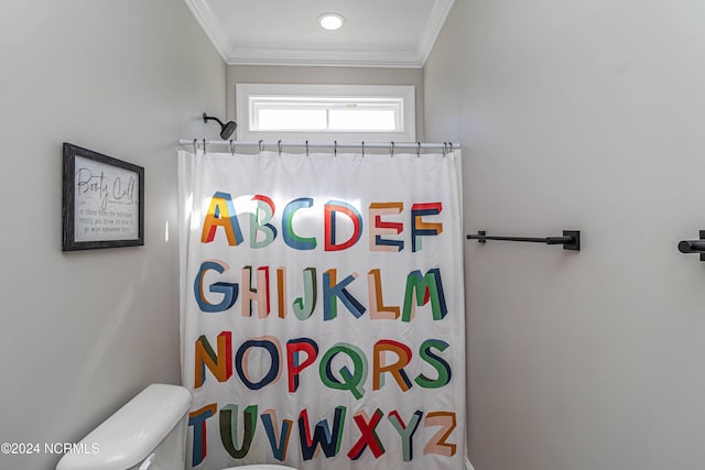 bathroom with crown molding, toilet, and a shower with shower curtain