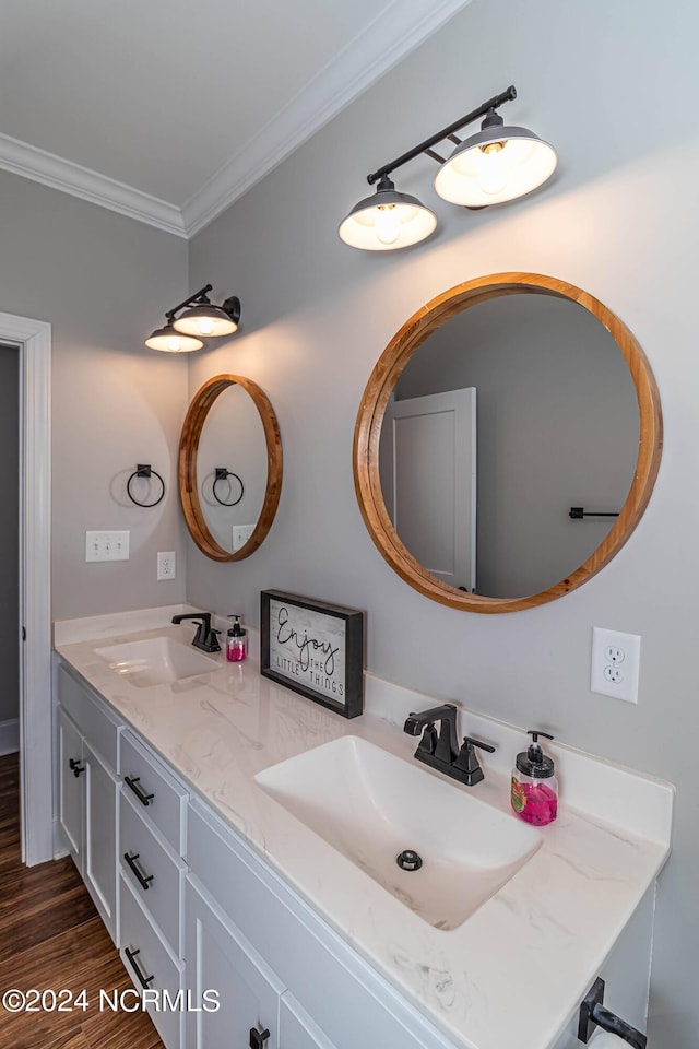 bathroom featuring hardwood / wood-style flooring, crown molding, and vanity