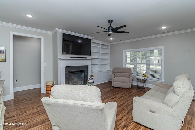 living room featuring crown molding, dark hardwood / wood-style floors, ceiling fan, and built in shelves