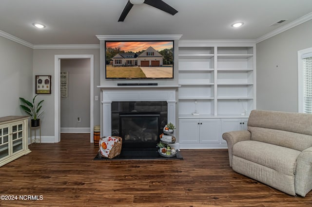 living room featuring built in shelves, ornamental molding, dark hardwood / wood-style floors, and ceiling fan