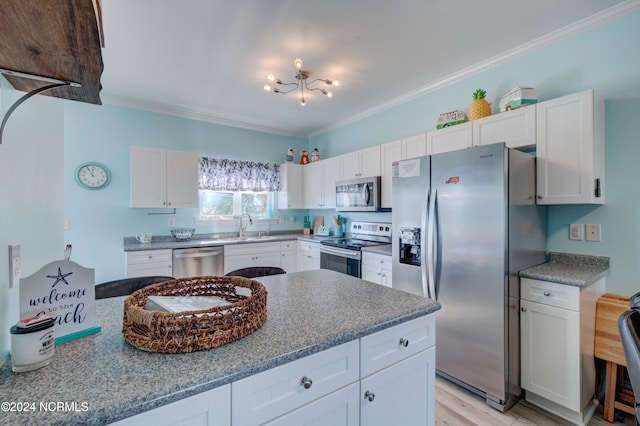 kitchen featuring white cabinetry, light hardwood / wood-style floors, appliances with stainless steel finishes, and ornamental molding