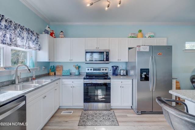 kitchen with light hardwood / wood-style flooring, white cabinets, stainless steel appliances, and sink