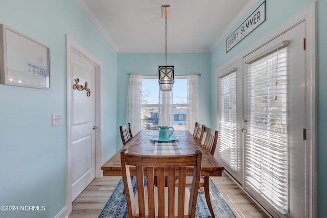 dining area with crown molding and light wood-type flooring