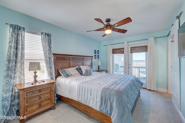 carpeted bedroom featuring ceiling fan, access to outside, and multiple windows