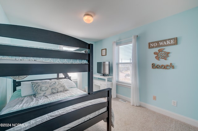 bedroom with light colored carpet