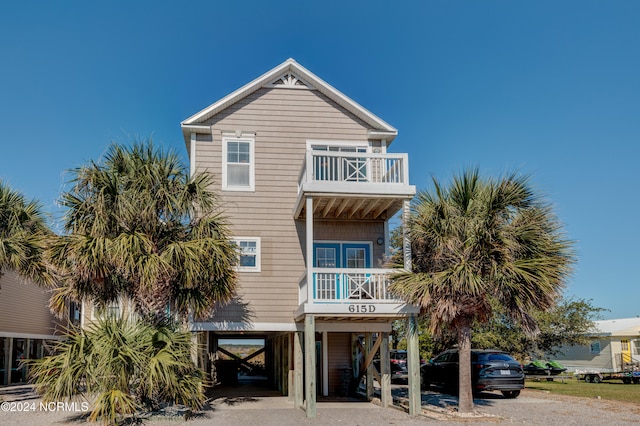 beach home featuring a balcony and a carport