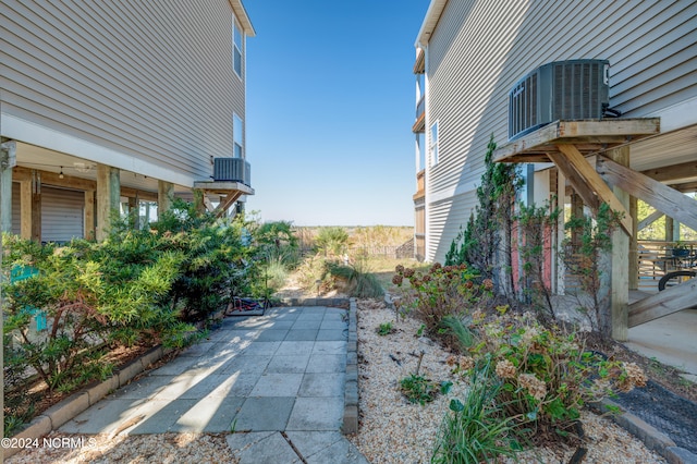 view of home's exterior with a patio and central AC unit