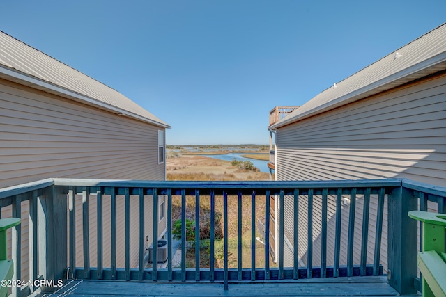 deck featuring a water view and central AC